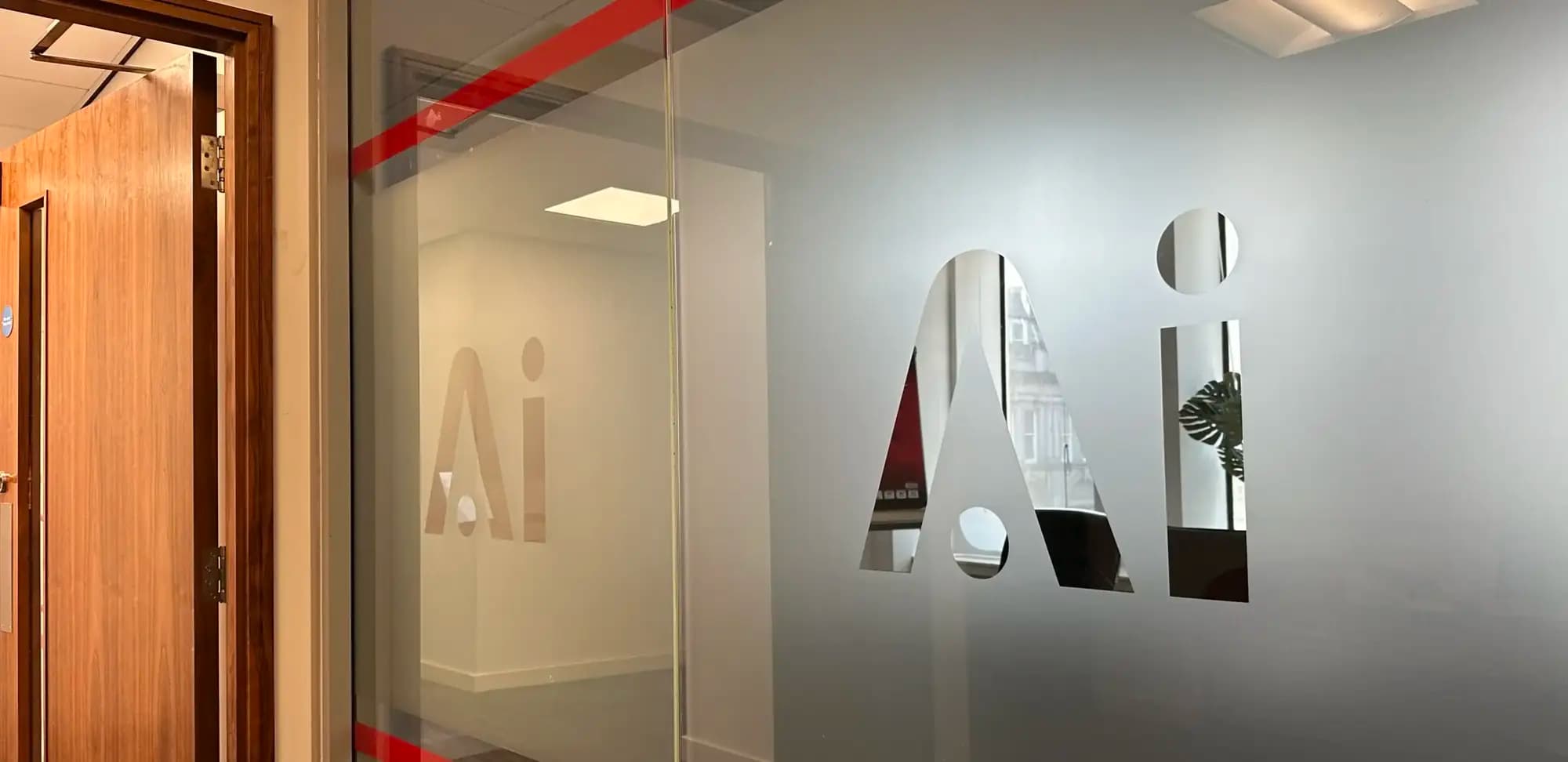 The etched Ai logo on the glass door of the Ai Law office