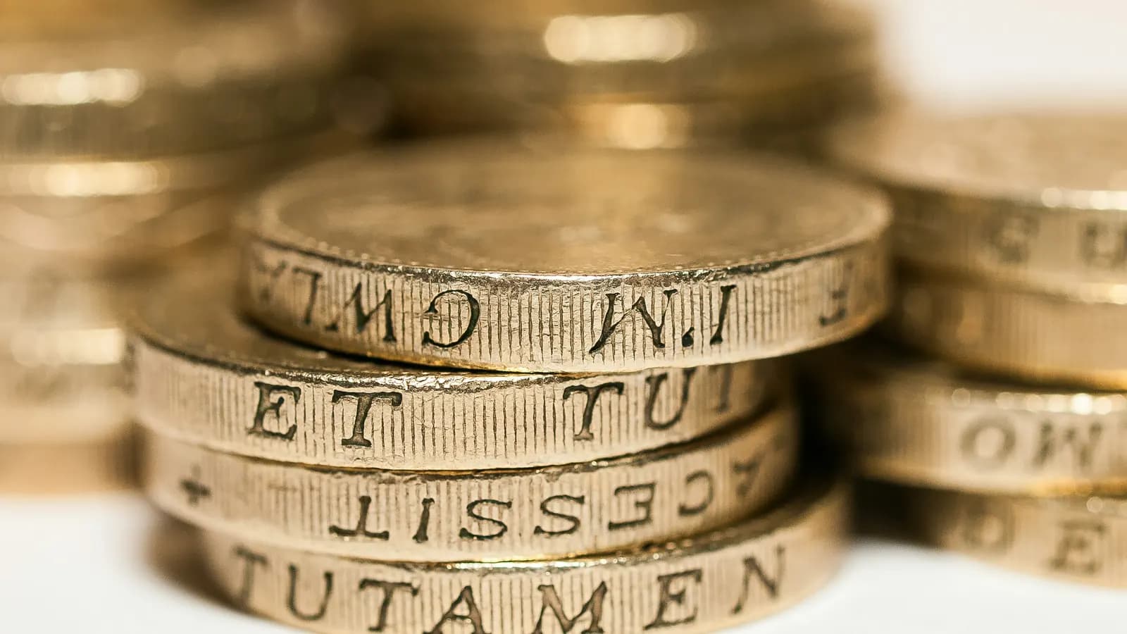 A close-up of stacked British pound coins