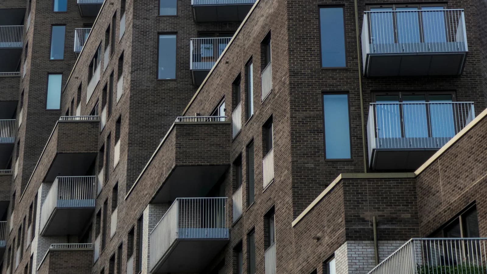 A modern brick block of flats with balconies in London