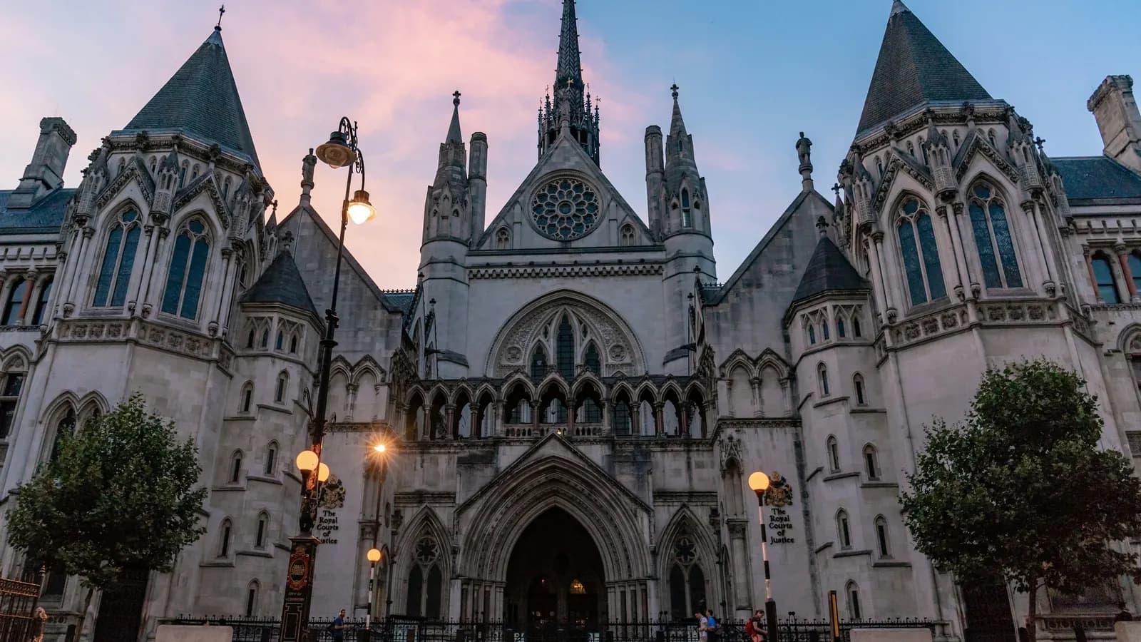 The Gothic front of the Royal Courts of Justice on the Strand, London, at dusk